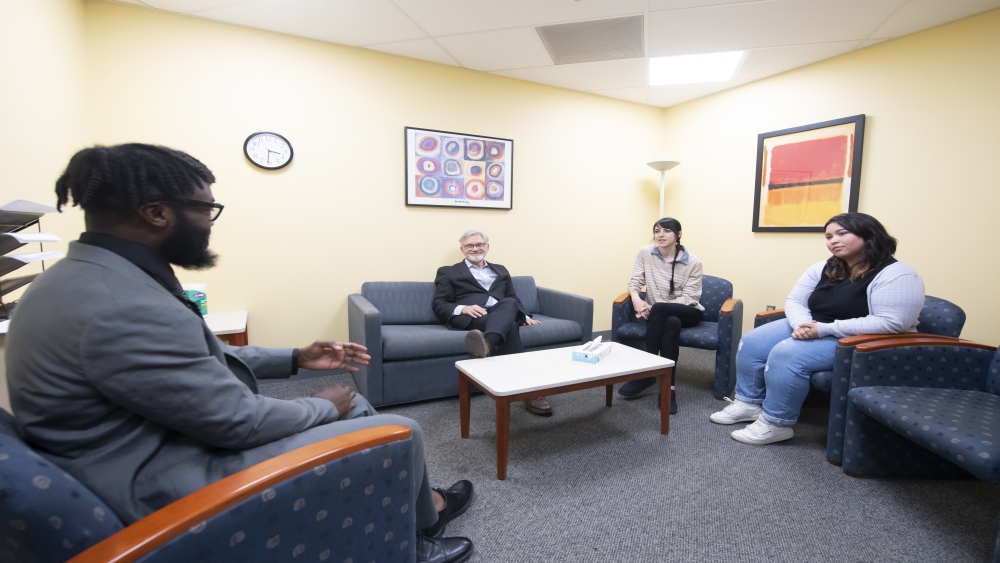 Clinical psychology center therapy room with four individuals. 