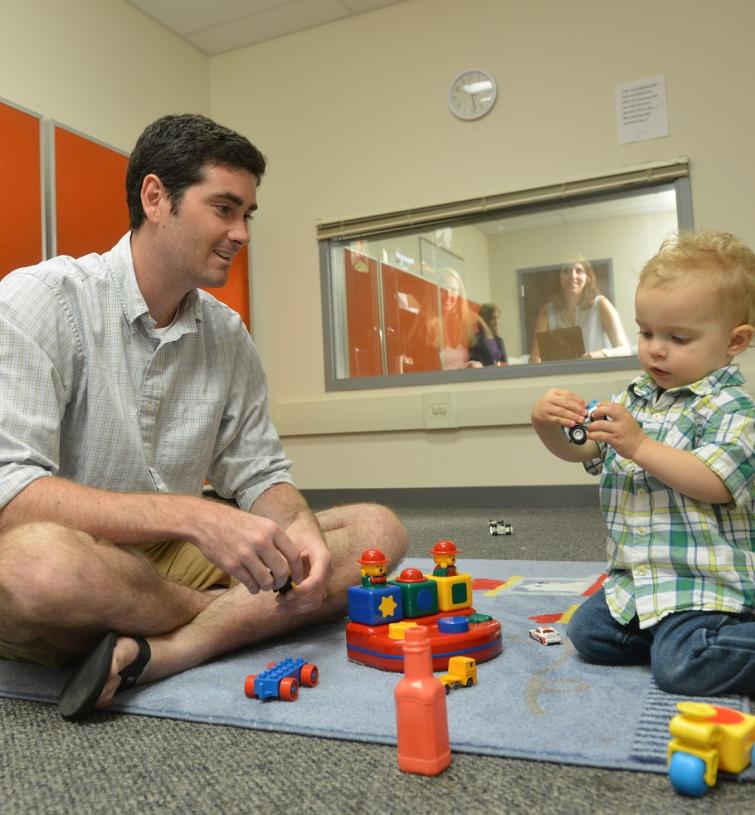 man observing child