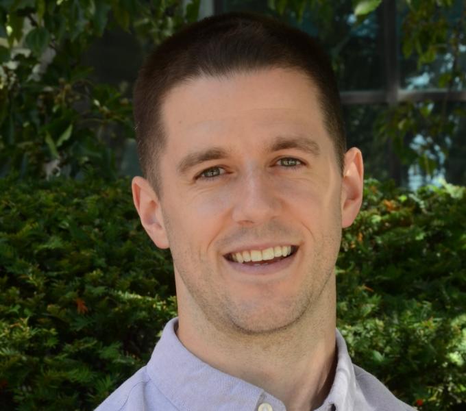 Colin E. Vize  headshot in front of plants