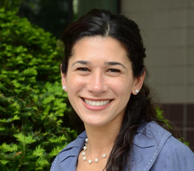 Tina R. Goldstein headshot in front of plant